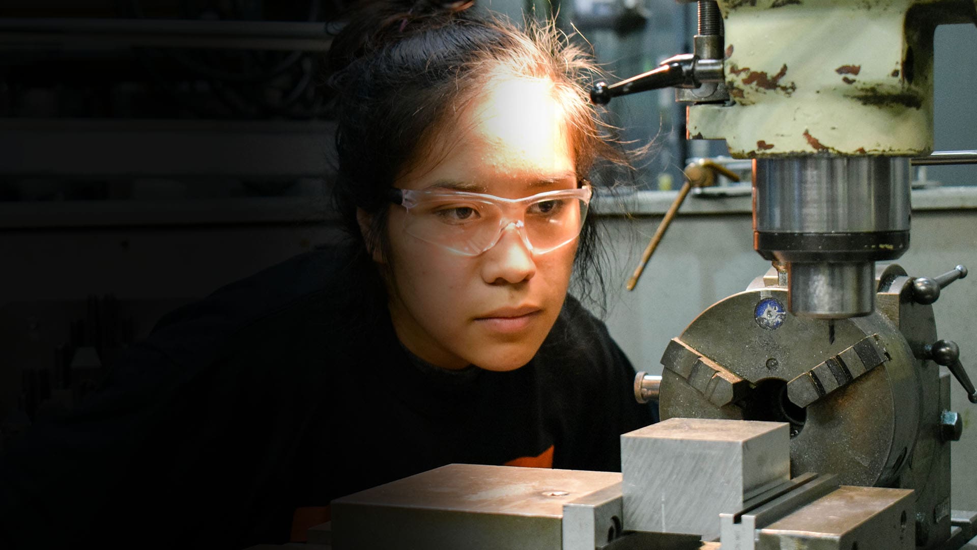 An AJAC youth apprentice uses a manual mill during her on-the-job training at Tool Gauge in Tacoma, Washington.