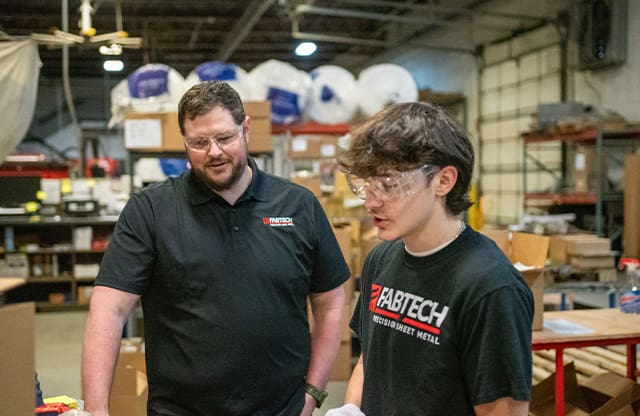 An AJAC Youth Apprentice works with his mentor at FabTech in Spokane, Washington.