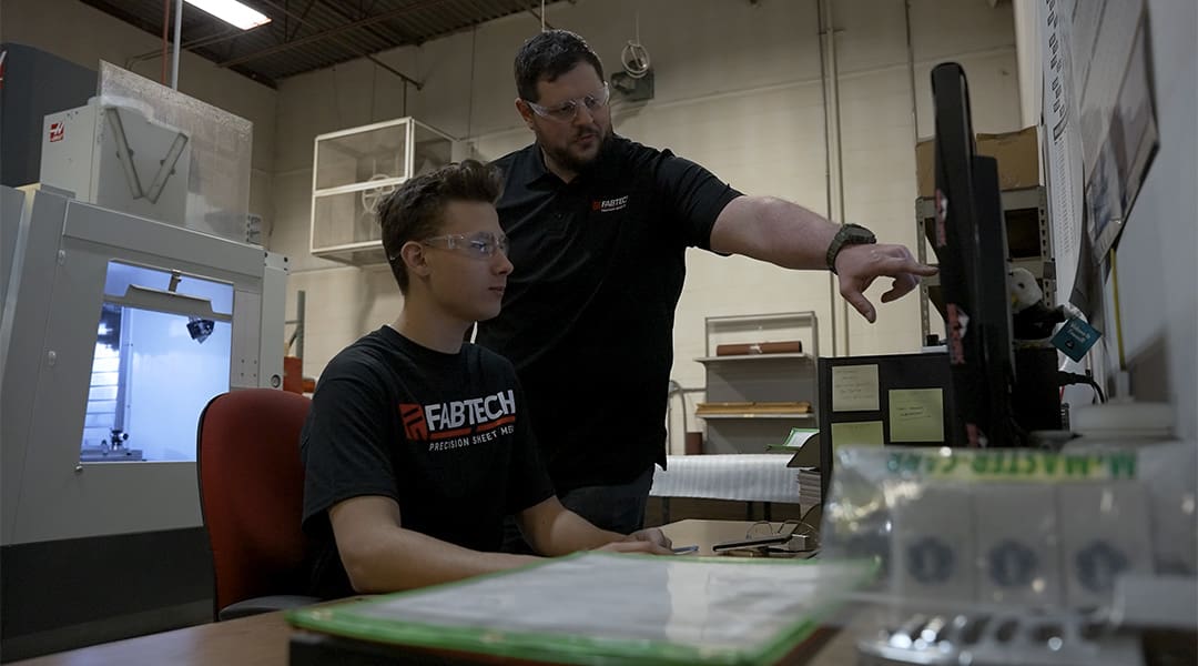 An AJAC Youth apprentice works on computer aided design with his mentor at FABTECH Precision Sheet Metal in Spokane Valley, Washington.