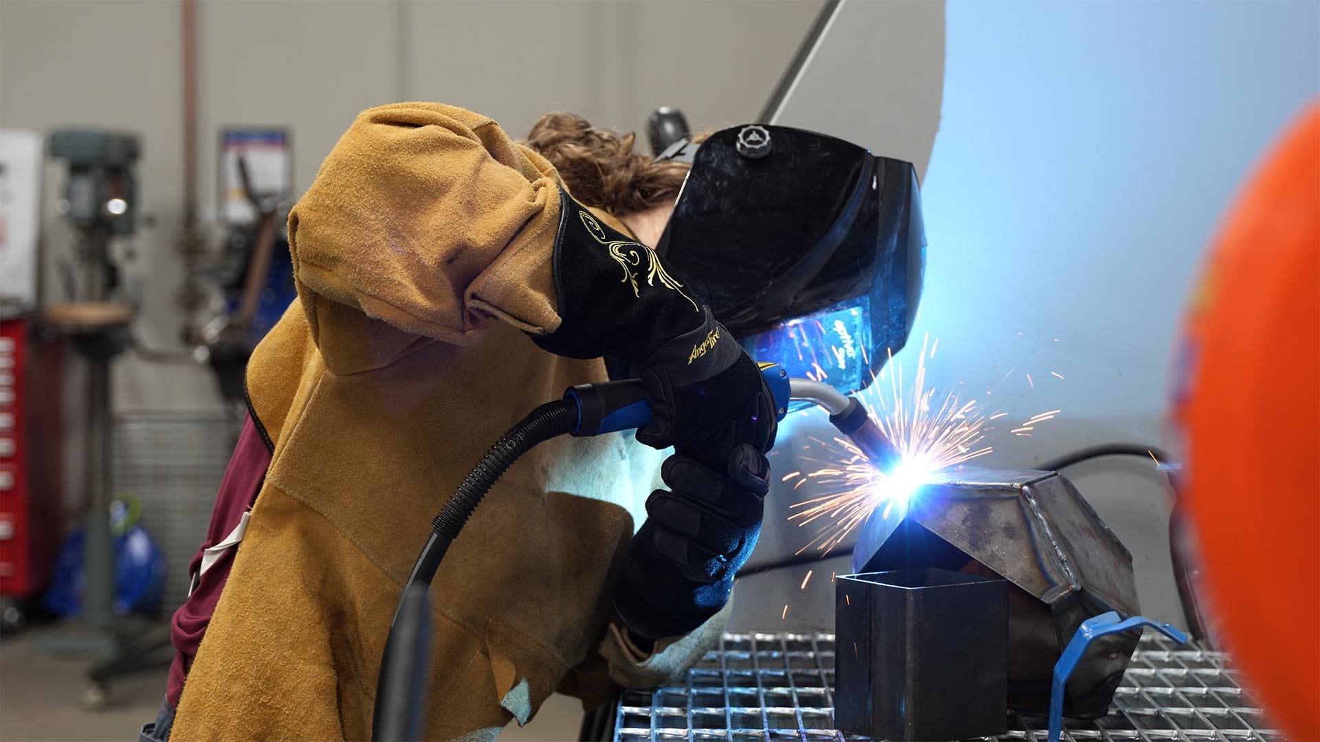 A student at the Lacey MakerSpace welds during class.